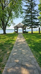 Scenic Gazebo Overlook with Stone Path and Lake View on a Sunny Day, Serene Landscape