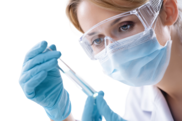 Female scientist conducting experiment with test tube and safety gear, cut out
