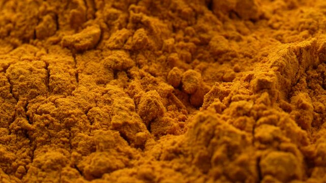 Macro video of turmeric powder kept on rotating disk. Close up of haldi powder.