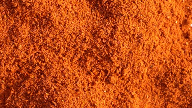 Macro video of red chilli powder kept on rotating disk. Close up of kashmiri chilli powder. 