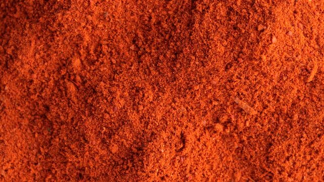 Macro video of red chilli powder kept on rotating disk. Close up of kashmiri chilli powder. 