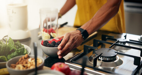 Berries, cooking and hands with man in kitchen of home for hobby, meal prep or nutrition. Ingredients, passion or recipe and person with bowl in apartment for breakfast, diet or health as chef