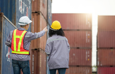 Back View of Engineer Man and Foreman Team Working at Industry Containers Cargo, Logistics Professional Inspecting Containers Box at Shipping Yard