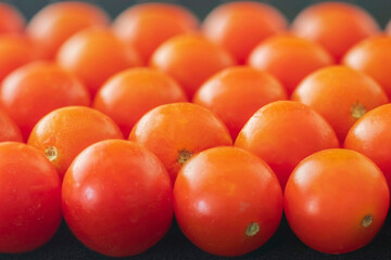 Close-up of fresh cherry tomatoes at a market.