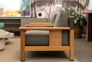 Modern wood-frame armchair with green cushions, side profile view