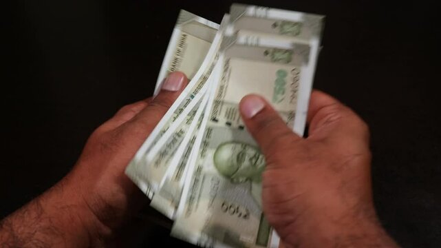 Person counting indian five hundred rupee notes and arranging in sequence. internal shot, close up shot, 4k.