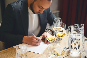 Sommelier examination to get certificate professional work of winemaking. Sommelier degustate wine.