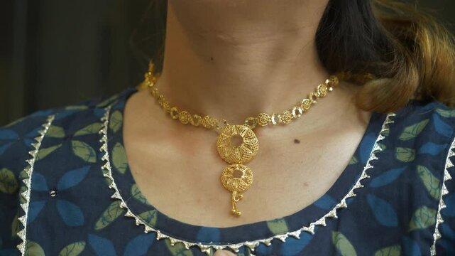 Young asian woman wearing designer gold necklace, 18k HUID certified gold necklace, Closeup