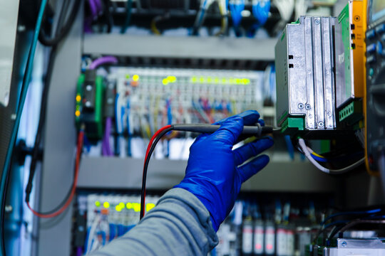 Engineer performing maintenance on medium voltage cell in wind turbine tower