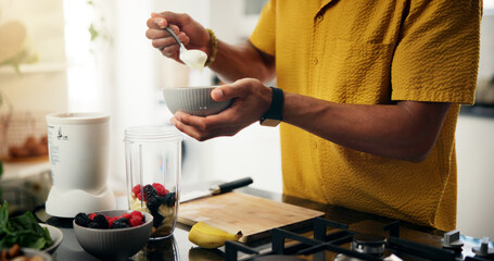 Berries, blender and hands with man in kitchen of home for hobby, meal prep or nutrition. Ingredients, recipe or smoothie and person with bowl in apartment for breakfast, diet or health as chef