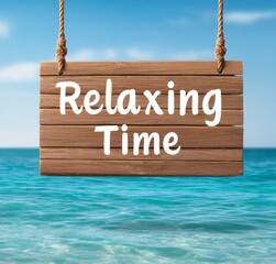 A wooden sign with the inscription "Relaxing Time", relaxation, rest and enjoyment on a beautiful beach above the turquoise sea and sandy shore invites you to rest and relaxation in the summer days.