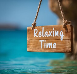 A wooden sign with the inscription "Relaxing Time", relaxation, rest and enjoyment on a beautiful beach above the turquoise sea and sandy shore invites you to rest and relaxation in the summer days.