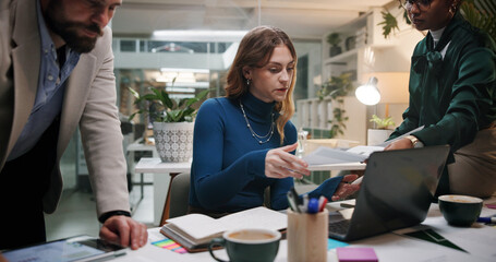Business people, paper and meeting in office for discussion, project feedback or advice at night. Journalist team, document and tech in agency for article planning, collaboration and late information