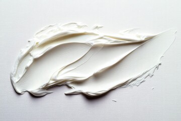 Smooth and creamy white thick paste smear with soft textured peaks and waves on a clean white surface