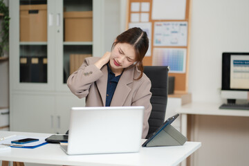 Business woman is doing a stretchy posture due to sitting in the office for too long, office...