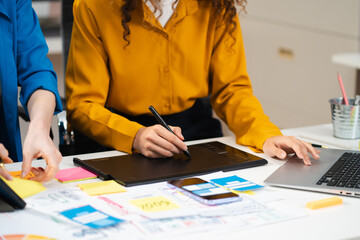 Creative digital development agency. developer team brainstorming on project with laptop, smartphone and digital tablet.