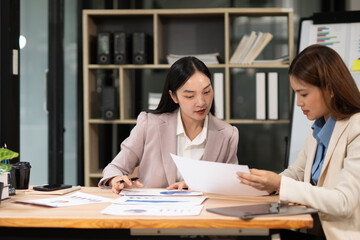 Two businesswoman hands or accountants working together on financial investment on calculator, calculating, analyzing business growth and marketing on graph.