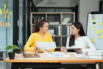 Two businesswoman hands or accountants working together on financial investment on calculator, calculating, analyzing business growth and marketing on graph.