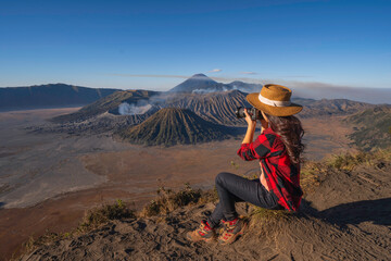 Travelers relax and enjoy the morning scenery at Mount Bromo. Located in Bromo, Tengger, Semeru National Park, East Java, Indonesia. 