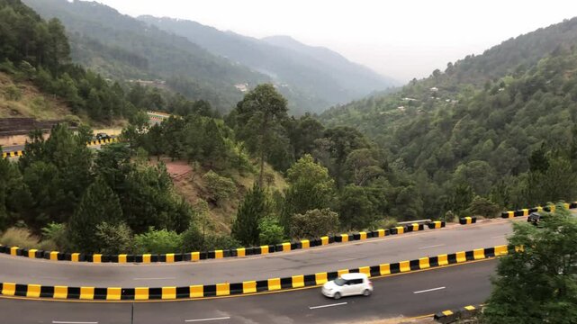 Aerial view of green hills with neat and clean motorways surrounded by trees in Murree, Pakistan,  Beautiful Mountain Hill Muree City, Arial shot of hill station in Murree Pakistan
