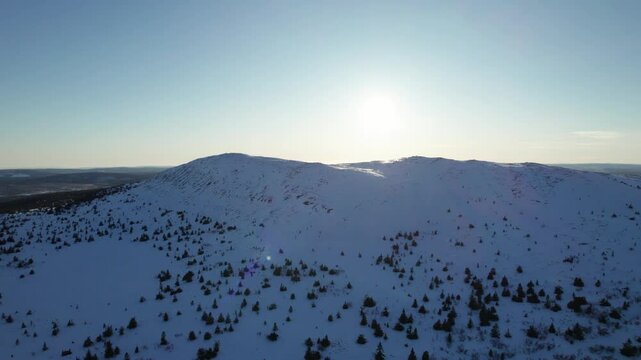Aerial Drone View of Winter Landscape Bathed in Sun, in Trysil Norway - Panning Shot