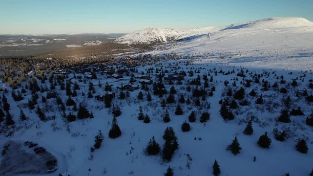 Aerial Drone View of Winter Landscape with Small Cabins in Trysil Norway - Upwards Panning Shot