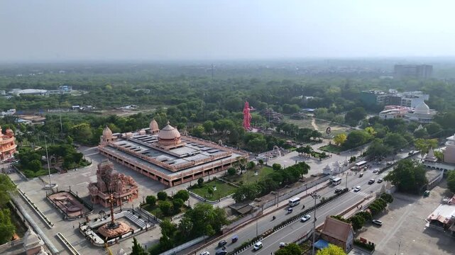 An Aerial Hyperlapse Shot of 101 foot tall, Hanuman Statue at Chhatarpur Temple, New Delhi, India
