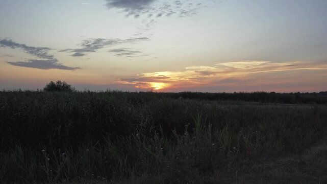 Sunset over Becej landscape with serene views of nature and open fields