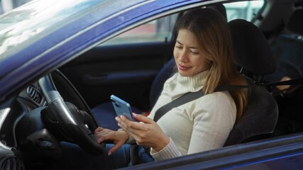 Woman driving car while using phone on urban street with sunlight reflecting on vehicle exterior showing safe driving habits