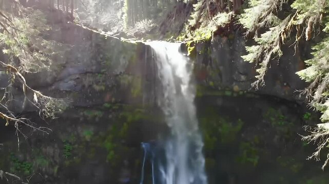 Aerial shot of amazing an amazing waterfall and moss covered rocks in Oregon
