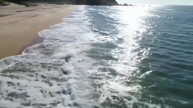 Aerial view of sandy beach and ocean with waves