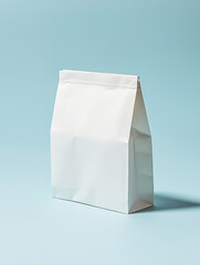Mockup for tea, coffee, cosmetics or food packaging. White paper bag on a light blue background. Copyspase for your text, design.