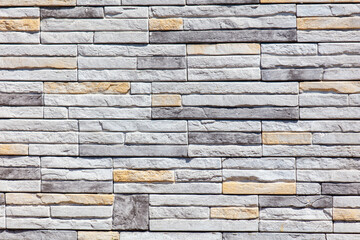 A wall made of gray and white bricks