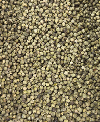 A close up of a bunch of green peppercorns