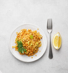 Red lentil dish with leek and carrot. Vegetarian cooking, top view, copy space