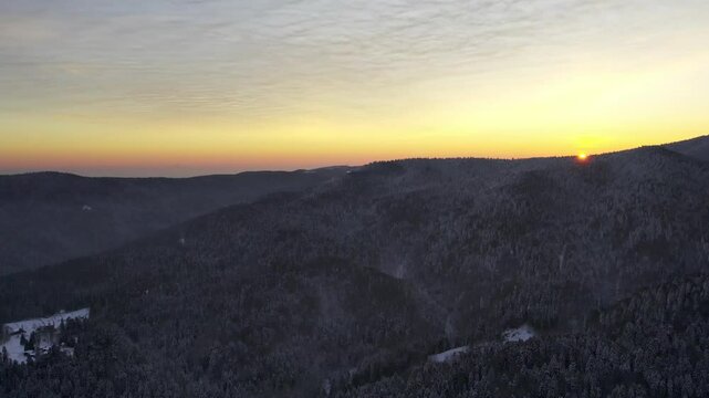 Serene winter sunset over the snowy mountains in Goc, Serbia, capturing nature's beauty at dusk