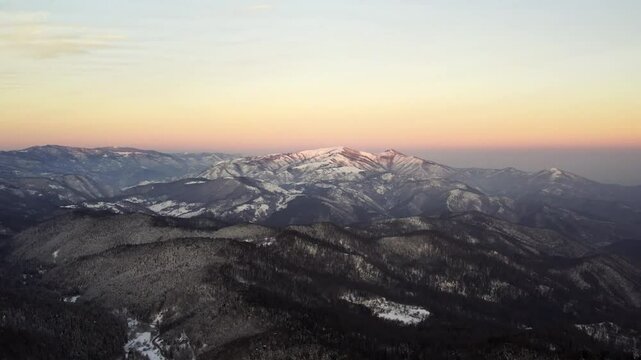 Sunset over the snow-capped mountains in Goc, Serbia showcasing breathtaking winter landscapes