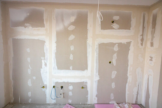 Assembled plasterboards on wall of an unfinished edifice on the building site