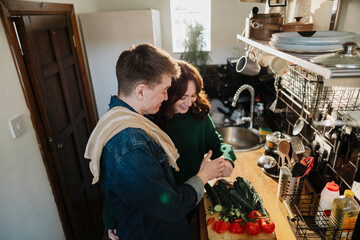 Couple cooking together in a kitchen with fresh vegetables