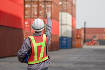 Back view of Engineer man working at industry containers cargo, Logistics professional inspecting...