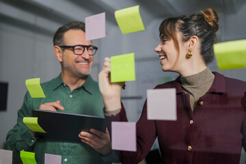 Business professionals brainstorming with sticky notes in an office