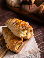 A tempting assortment of freshly baked pastries, featuring creamy custard-filled puff pastries