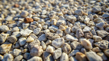 Close up view of small white and gray pebbles in sunlight
