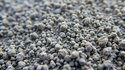 Close up view of gray granular material small pebbles or aggregate