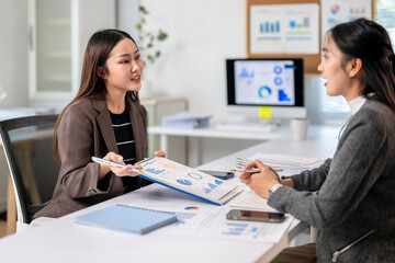 Two women are talking in a business meeting