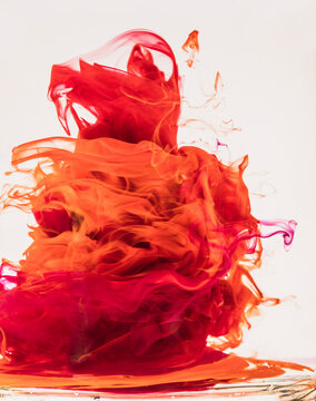 Vibrant ink tornados twist and dance in clear water