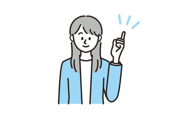 笑顔で指差しポーズをとるスーツの女性