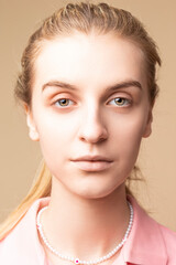 Closeup Portrait of Young Tranquil Caucasian Blond Woman With Facial Skin Problems Pustules On Beige.