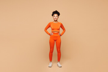 Full body young happy fitness trainer instructor sporty woman sportsman wear orange clothes spend...