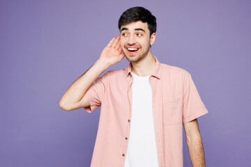 Young curious nosy happy man he wears pink shirt t-shirt casual clothes try to hear you overhear...